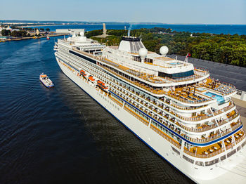 High angle view of ship moored on sea against buildings