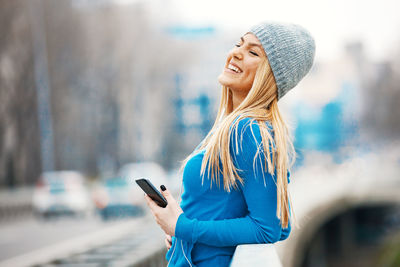 Young woman using mobile phone outdoors