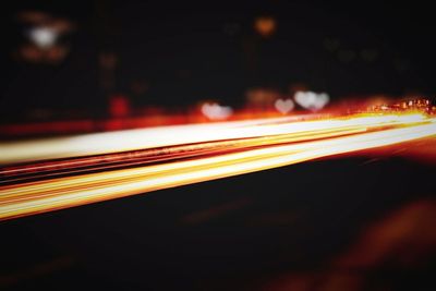 Close-up of light trails on road at night