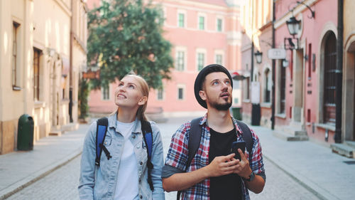 Young couple standing on street in city
