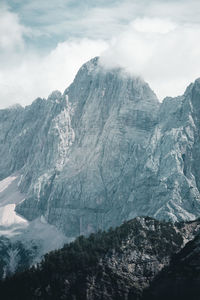Scenic view of rocky mountains against cloudy sky