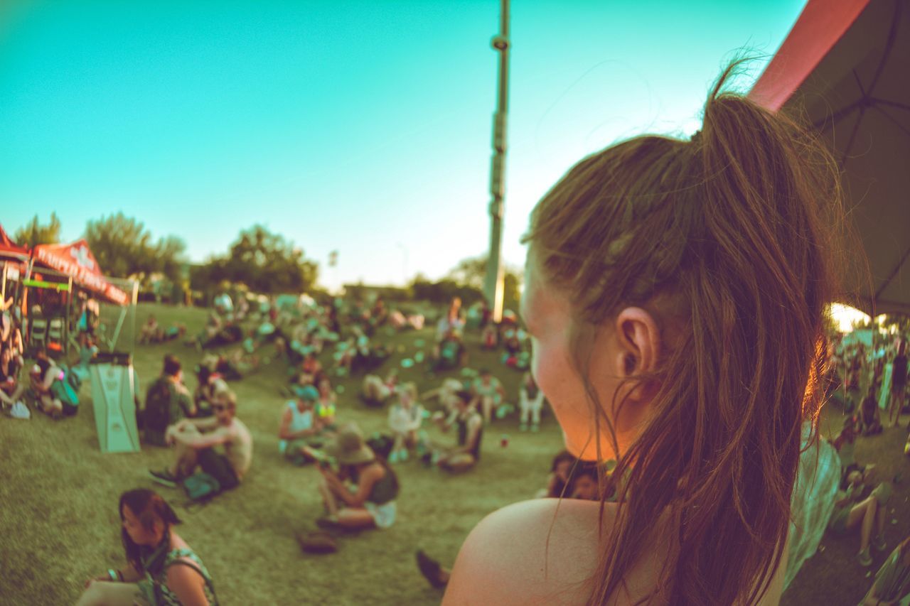 real people, leisure activity, music festival, focus on foreground, outdoors, enjoyment, arts culture and entertainment, large group of people, young adult, music, happiness, lifestyles, day, young women, women, crowd, grass, tree, sky, nature, people, adult