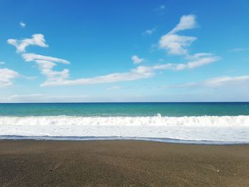 Scenic view of sea against blue sky