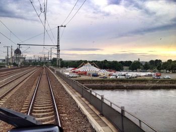 Railroad track against cloudy sky