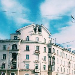 Low angle view of building against cloudy sky