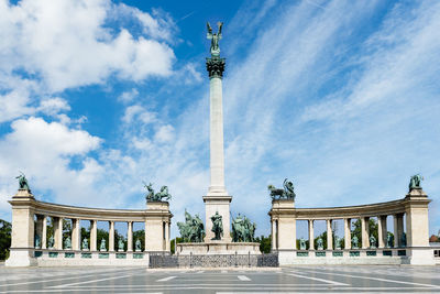 Low angle view of monument against cloudy sky