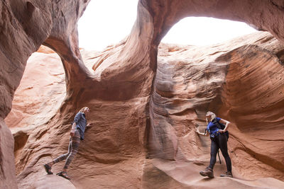 Low angle view of female hikers exploring at canyon