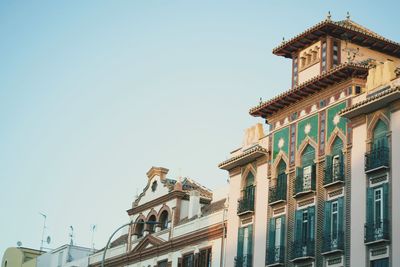 Low angle view of buildings against blue sky