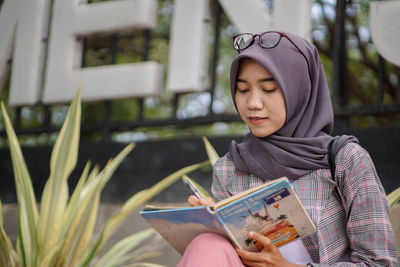 Portrait of young woman using mobile phone