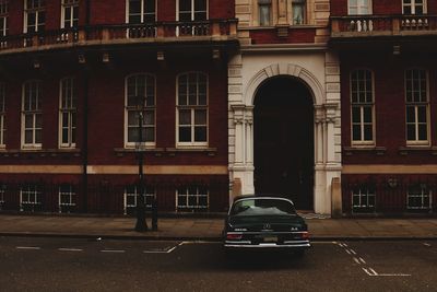 Car on street against buildings in city