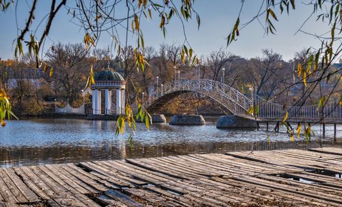 Bridge over the lake on a sunny autumn evening in the village of ivanki, cherkasy region, ukraine