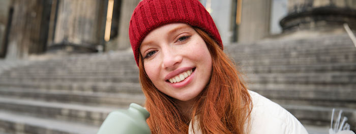 Portrait of young woman in city