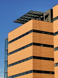 Low angle view of modern building against clear blue sky