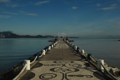 Pier over sea against sky