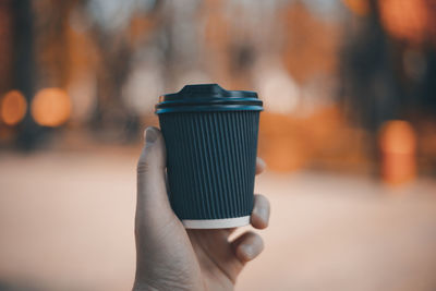 Close-up of hand holding tea cup