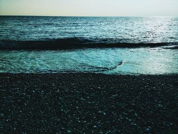 Close-up of sea against sky during sunset