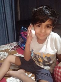 Portrait of boy sitting at home