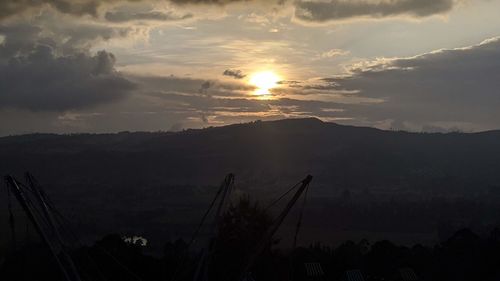 Scenic view of silhouette mountains against sky at sunset