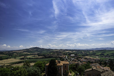 Aerial view of buildings in town against sky