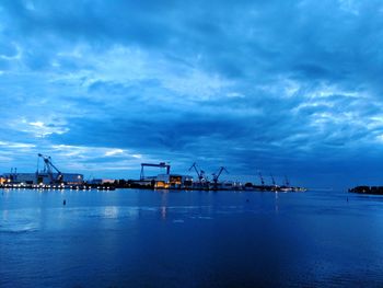 Commercial dock by sea against sky