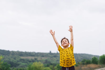 A six-year-old boy runs in the countryside.