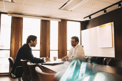 Male lawyer planning with customer in meeting at office