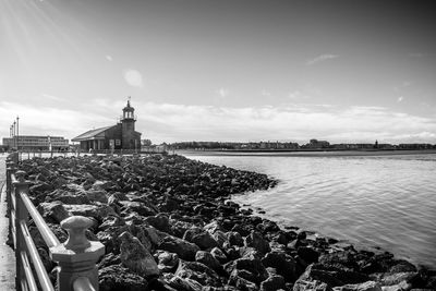 A black and white of the lighthouse on the stone jetty in morecombe