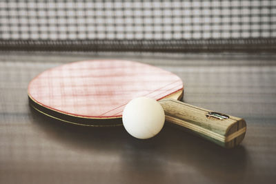 Close-up of ball and bat on table