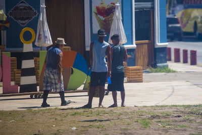 Rear view of people standing on street