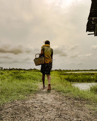 Rear view of man standing on field