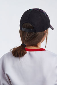 Rear view of woman wearing hat against white background