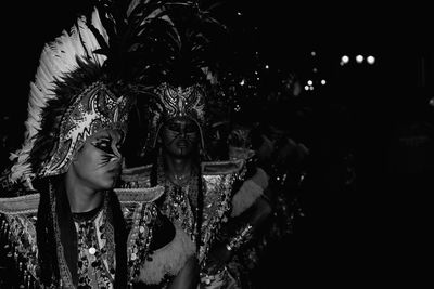 Young woman in traditional clothing at night