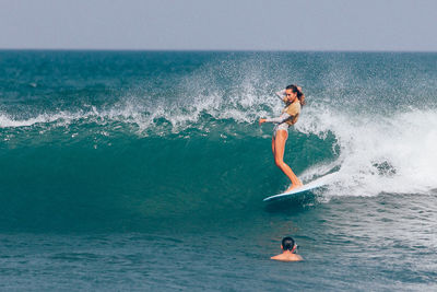 Woman surfing in sea