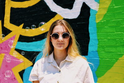 Portrait of smiling young woman wearing sunglasses