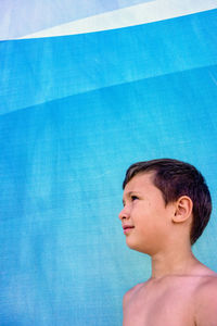 Close-up of shirtless boy in swimming pool
