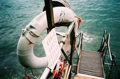 Life belt on railing against sea