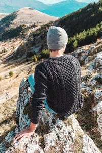 Rear view of man on rock