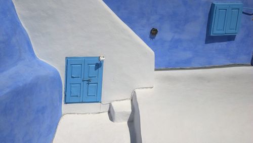 High angle view of closed windows of house at santorini