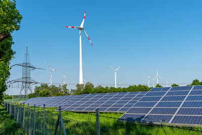 Solar panels, wind engines and an electricity pylon seen in germany