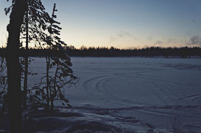 Close-up of frozen lake against sky during winter