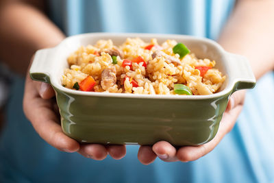 Midsection of person holding food in bowl