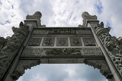 Low angle view of historical building against cloudy sky