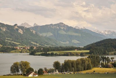 Scenic view of lake and mountains against sky