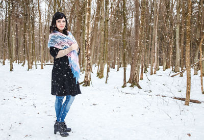 Full length of woman standing in snow
