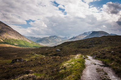 Scenic view of mountains against cloudy sky