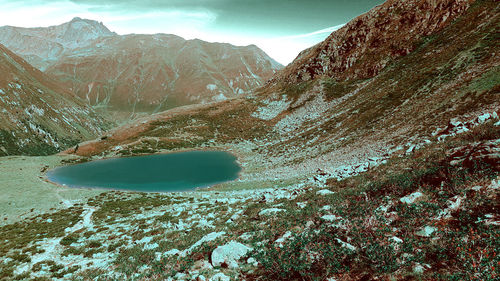 Scenic view of snow covered mountains against sky
