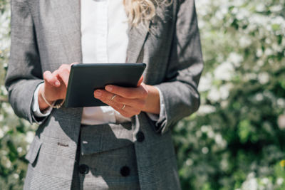 Midsection of man using mobile phone