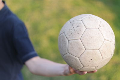 Close-up of human hand on grass