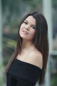 Portrait of smiling young woman standing outdoors