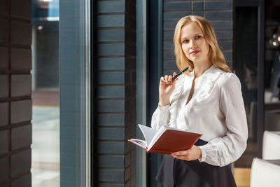 Woman standing by window